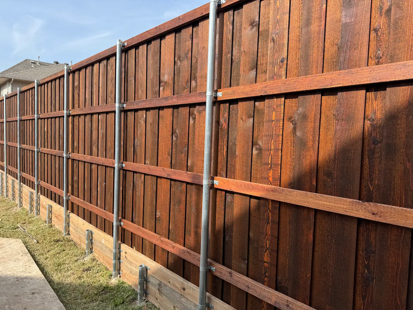 Tall cedar privacy fence enclosing a Dallas backyard